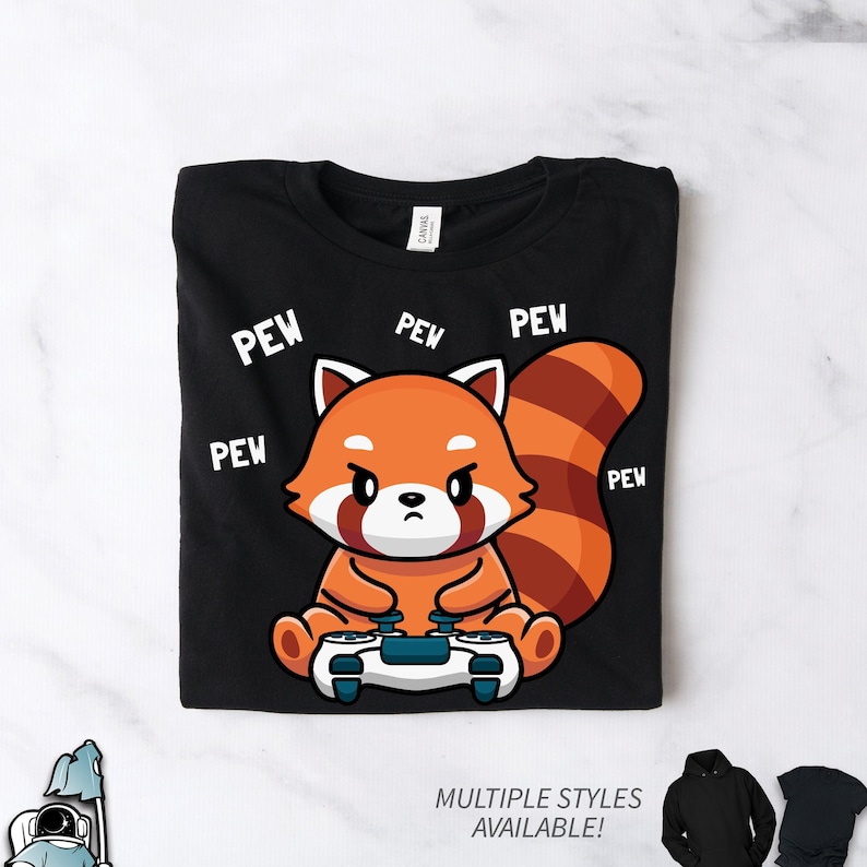 May include: Black t-shirt with a red panda holding a video game controller. The panda is surrounded by the word "pew" in white text.