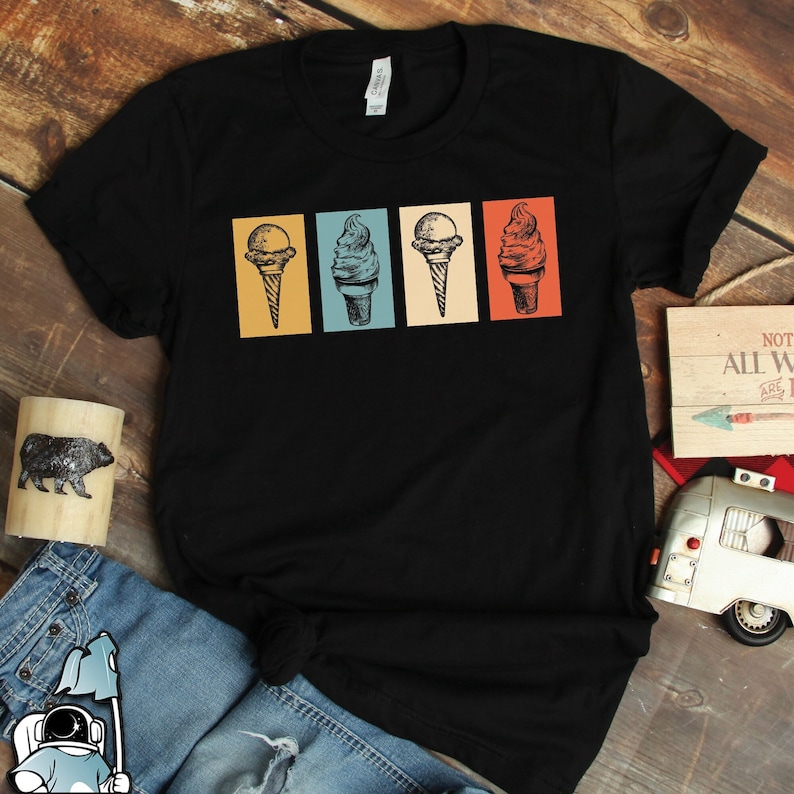 May include: Black t-shirt with a retro design of four ice cream cones in different colors. The ice cream cones are in a row, each in a different colored square.