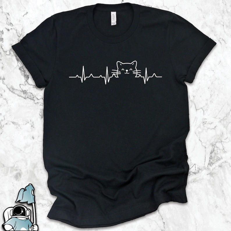 May include: Black t-shirt with a white graphic of a cat's face inside a heartbeat line.