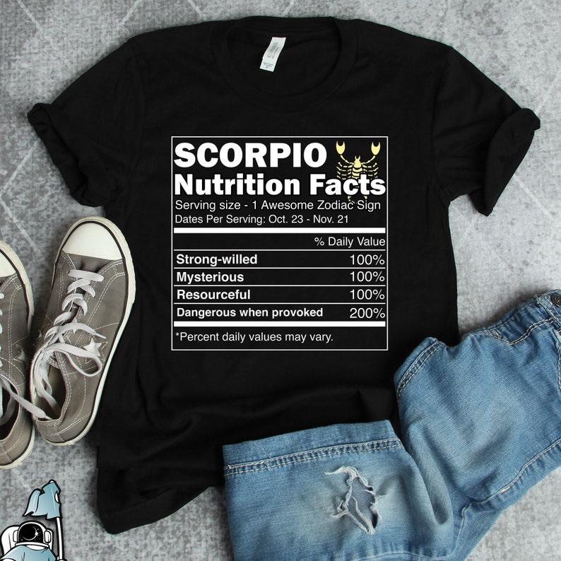 May include: Black t-shirt with a white graphic of a nutrition facts label for the Scorpio zodiac sign. The label lists traits like strong-willed, mysterious, resourceful, and dangerous when provoked, with a percentage value for each trait. The graphic includes a scorpion symbol.