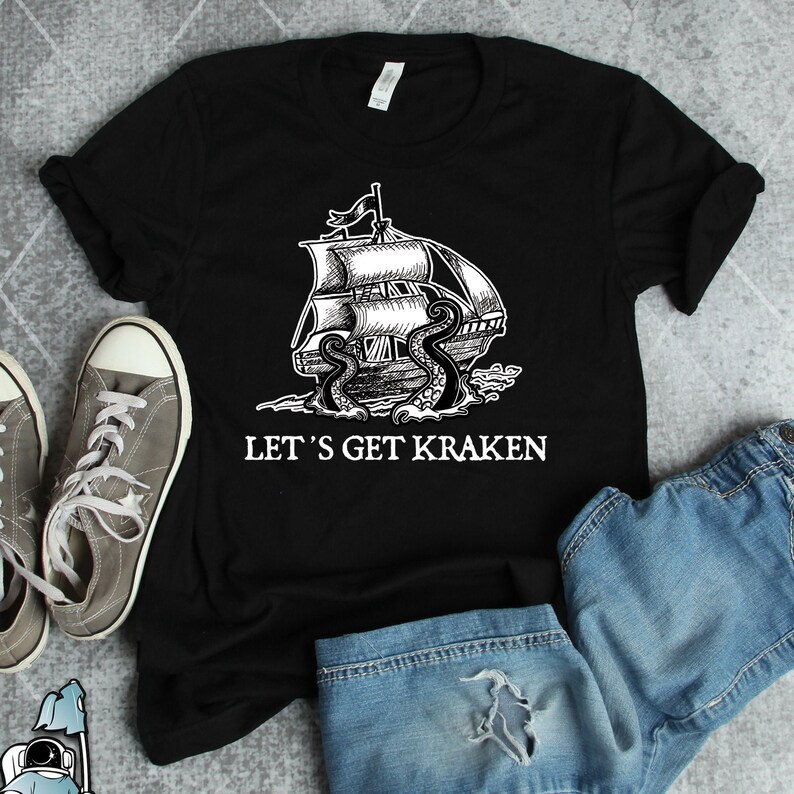 May include: Black t-shirt with a white graphic of a ship being attacked by a kraken. The text "Let's Get Kraken" is printed below the graphic.