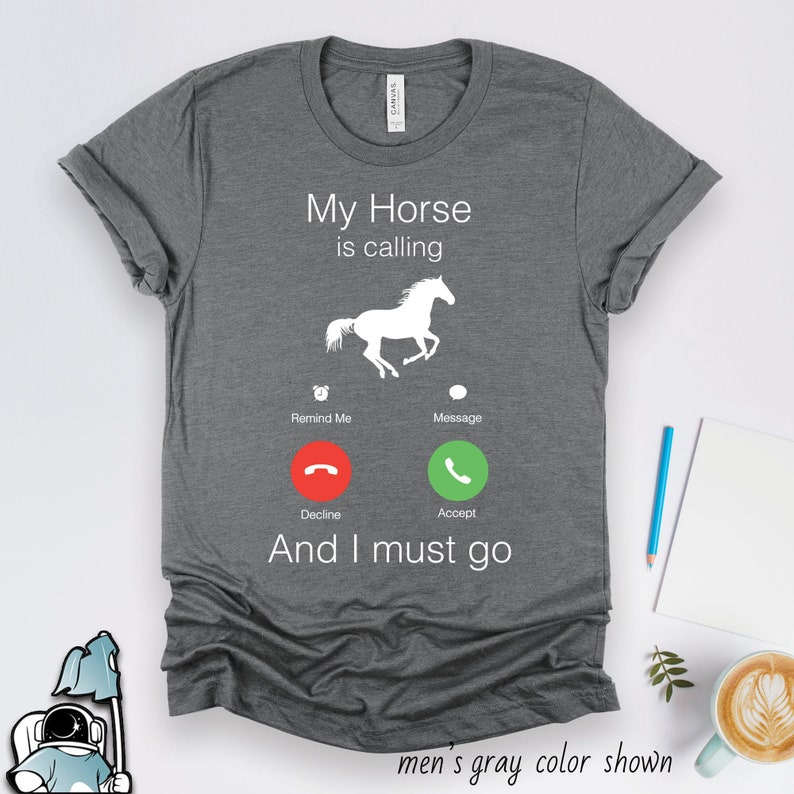 May include: Gray t-shirt with a white silhouette of a horse and a phone icon with the text "My Horse is calling" and "And I must go".