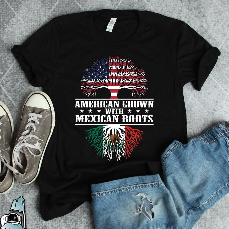 May include: Black t-shirt with a tree design featuring the American and Mexican flags. The text "American Grown with Mexican Roots" is printed on the shirt.
