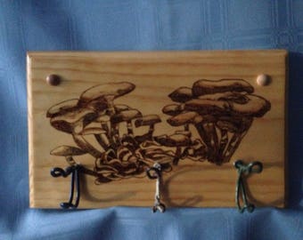 Wall mount coat hook, wood with three metal hooks.