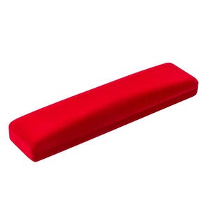 May include: A long, rectangular red velvet jewellery box. The box has rounded edges and a soft, plush texture. The bright red colour makes it stand out against the white background. This box is designed to hold jewellery.