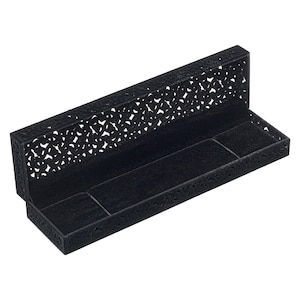 May include: Black velvet-lined jewellery box with a decorative, openwork design. The box is open and the lid is lying flat.