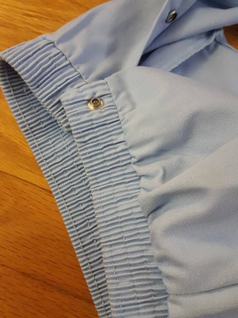 Retro light blue snap button up hoodie-less vest with neck drawstring