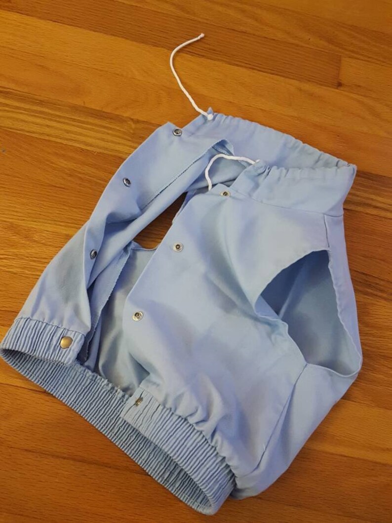 Retro light blue snap button up hoodie-less vest with neck drawstring