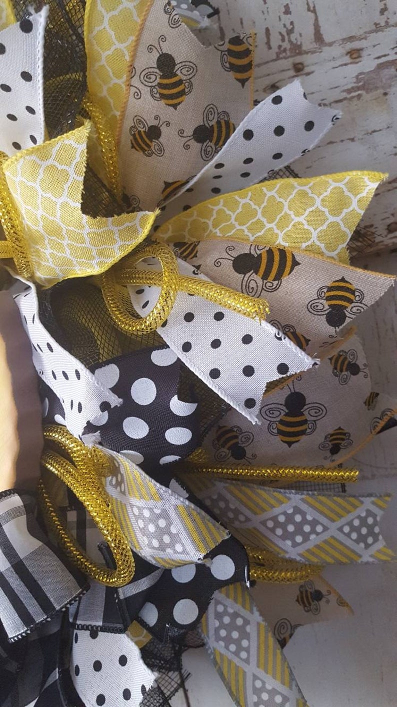 Bumble bee wreath with a large metal bee attached.