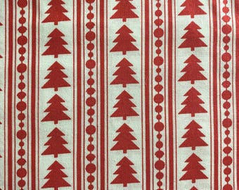 May include: A fabric with a repeating pattern of red Christmas trees and red vertical stripes on a white background. The stripes alternate between solid lines and lines of red circles, creating a festive holiday design.