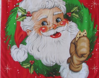 May include: A red and black plaid fabric panel with a white border. The panel features a festive image of Santa Claus with a green holly wreath, holding a cookie. The text "Here Comes Santa Claus" is printed in white on the panel.