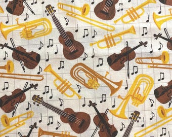 May include: Fabric with a repeating pattern of musical instruments including brown violins, guitars, and yellow trumpets. Black musical notes are scattered across the white background.