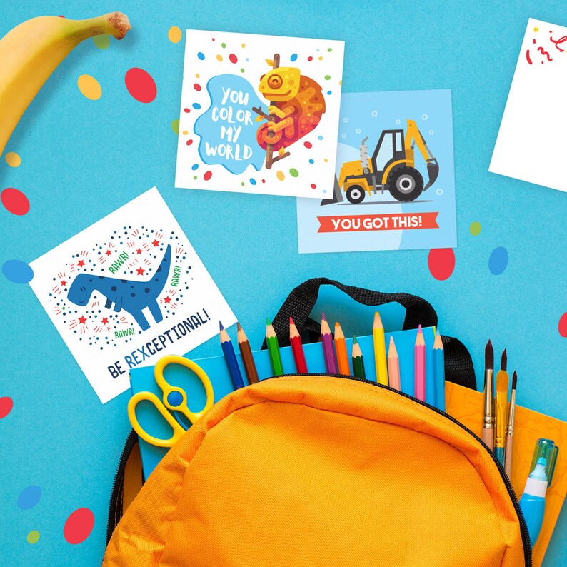May include: Four colorful cards with encouraging messages for kids. The cards feature a dinosaur, a chameleon, a construction vehicle, and a blank card. The cards are on a blue background with a yellow backpack, pencils, and scissors.