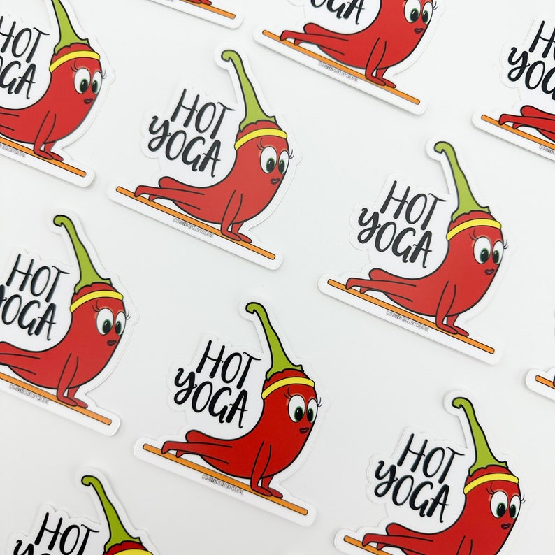 May include: A set of nine red chili pepper stickers with green stems and yellow bands. Each sticker features the text "HOT YOGA" in black cursive lettering.