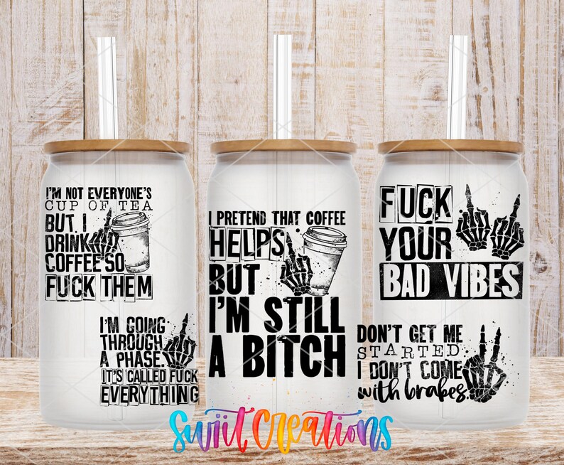 three white tumblers with black text and graphics printed on them. The text appears to be a humorous and edgy take on coffee culture, with phrases such as "I'm not everyone's cup of tea", "Drink coffee so I can fuck them", "I pretend that coffee helps me through a phase", "I'm still a shit", and "FUCK YOUR BAD VIBES". The tumblers are displayed against a wooden background, which adds to the overall edgy and unconventional aesthetic of the image.