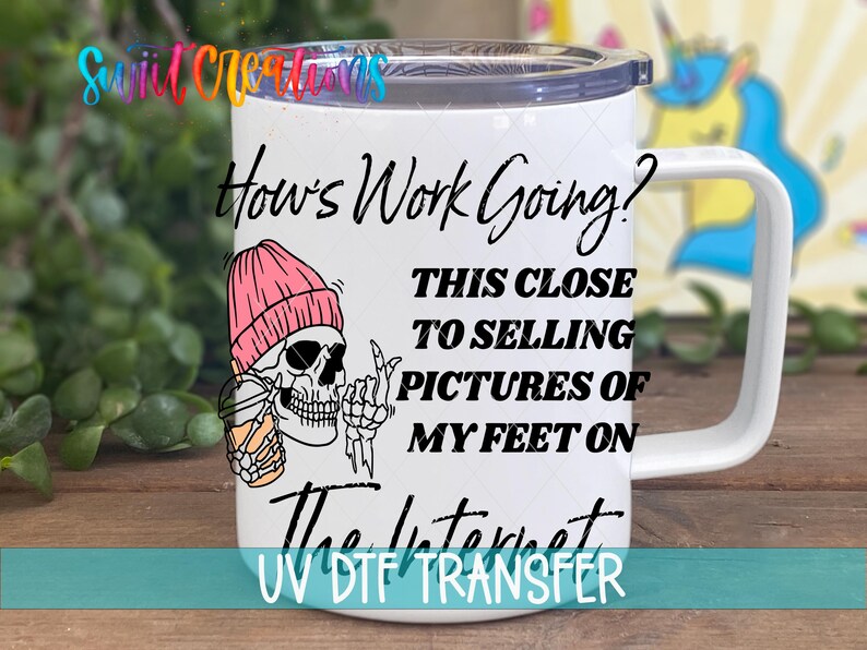A white mug with a skeleton wearing a pink beanie and holding a drink, along with text that says "How's Work Going? This Close to Selling Pictures of My Feet on the Internet".
