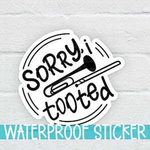 May include: A black and white waterproof sticker with a trombone and the text "Sorry I tooted".