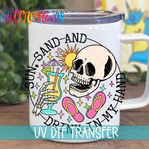 A white mug with a colorful design featuring a skeleton holding a drink and beach-themed elements, such as a sun, sand, and flip flops.