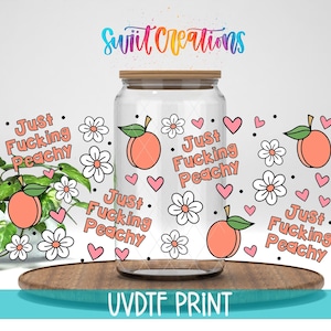 May include: A clear glass jar with a wooden lid, decorated with peach and flower graphics, pink hearts, and the text "Just Fucking Peachy." The jar sits on a wooden tray. The text "UVDTF PRINT" is at the bottom.
