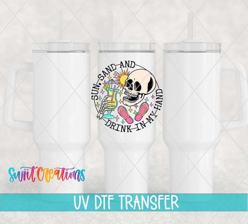 three white tumblers with a colorful design on the center, including a skull and a sun-like symbol. The text "Sun-Sand-And Drink-In My Hand" is displayed on the tumbler.
