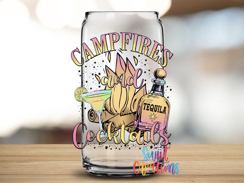 a glass with a colorful design that includes a tequila bottle, cocktail glasses, and a campfire, along with the text "Campfires and Cocktails" and "Suitcase Creations".