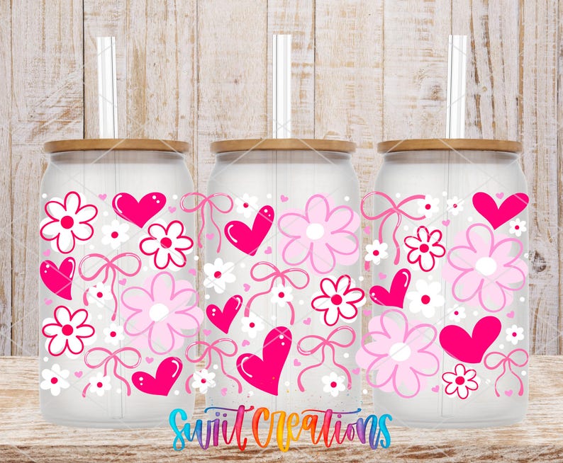three glass tumblers with a floral design on them, including pink hearts, flowers, and bows.