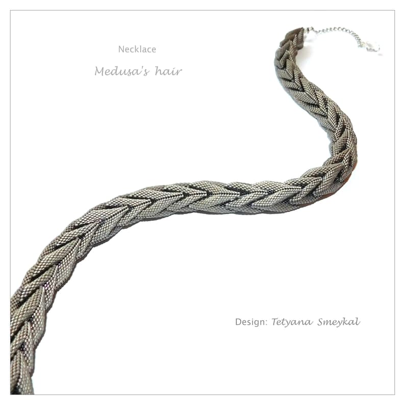 May include: A silver necklace with a braided chain design. The necklace is called "Medusa's Hair" and is designed by Tetyana Smeykdal.