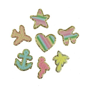 May include: A collection of colorful embroidered patches in various shapes, including a star, heart, airplane, anchor, flamingo, and palm tree. Each patch features a gold glitter border and pastel-colored striped or textured designs. Perfect for adding flair to clothing or accessories.