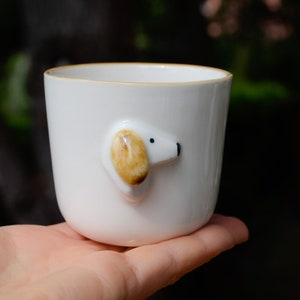 May include: White ceramic mug with a small, 3D dog face on the side. The dog has brown ears and black eyes.