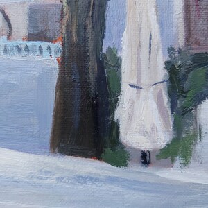 May include: A close-up of a white canvas painting with a focus on a white object with a dark brown object to the left and a green object to the right. The white object is in the center of the image and is the main focus.