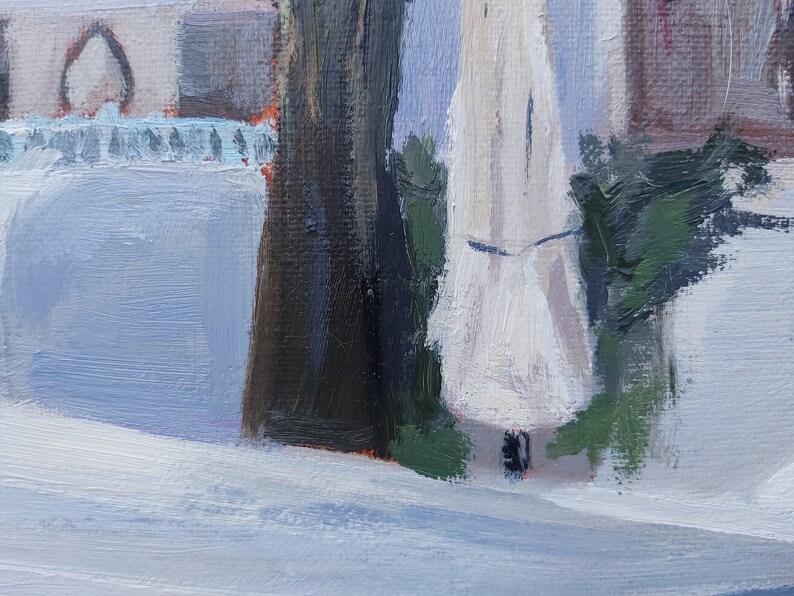 May include: A close-up of a white canvas painting with a focus on a white object with a dark brown object to the left and a green object to the right. The white object is in the center of the image and is the main focus.