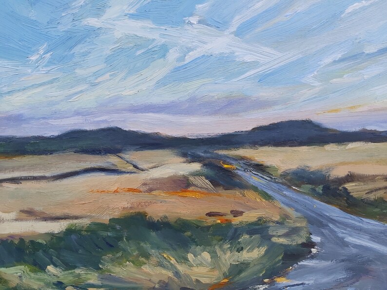May include: A painting of a landscape with a road leading into the distance. The sky is a light blue with white clouds, and the ground is a mix of brown and green. The road is a light gray color.