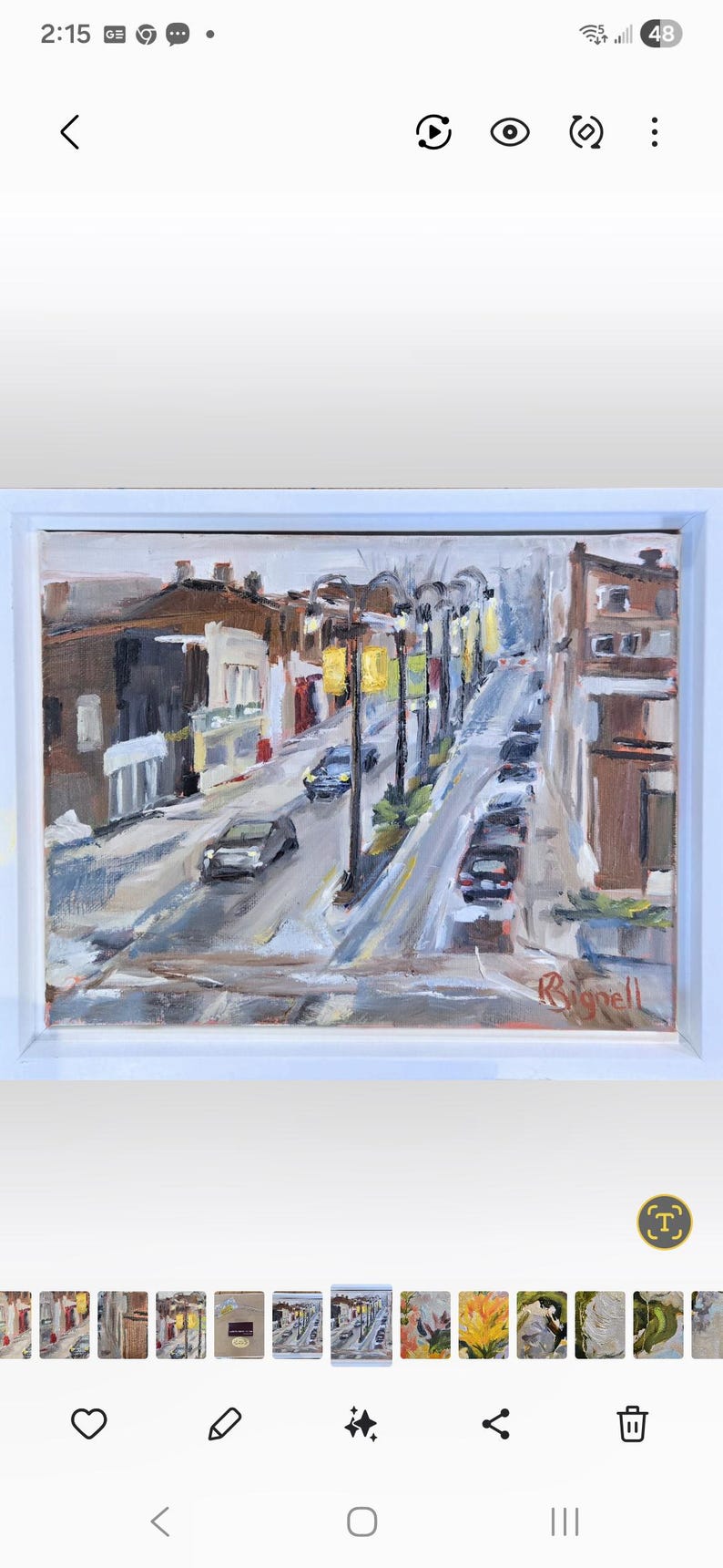 May include: Oil painting of a city street scene with buildings, cars, and streetlights. The artwork is framed in a white border. The painting uses a palette of browns, yellows, and grays to depict the urban landscape.