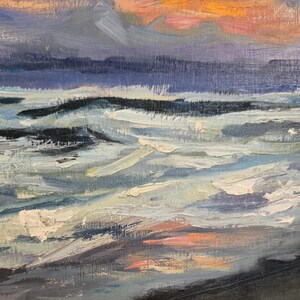 May include: An oil painting depicting a seascape at sunset. The sky features hues of orange, pink, and purple, with dark blue clouds. The water is a mix of blues and whites, with visible brushstrokes creating a textured effect.