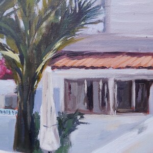 May include: A painting of a white building with a terracotta roof and a palm tree in the foreground. The building has a large window and a white door. The palm tree has green leaves and a brown trunk.