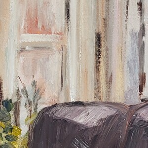 May include: A close-up of a dark brown, textured, fabric surface. The fabric is in the foreground of the image and is partially obscured by a blurred background of a white wall with vertical brushstrokes.
