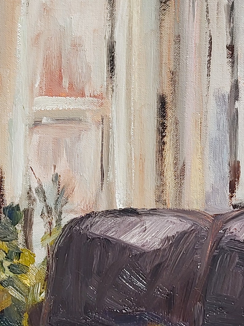 May include: A close-up of a dark brown, textured, fabric surface. The fabric is in the foreground of the image and is partially obscured by a blurred background of a white wall with vertical brushstrokes.