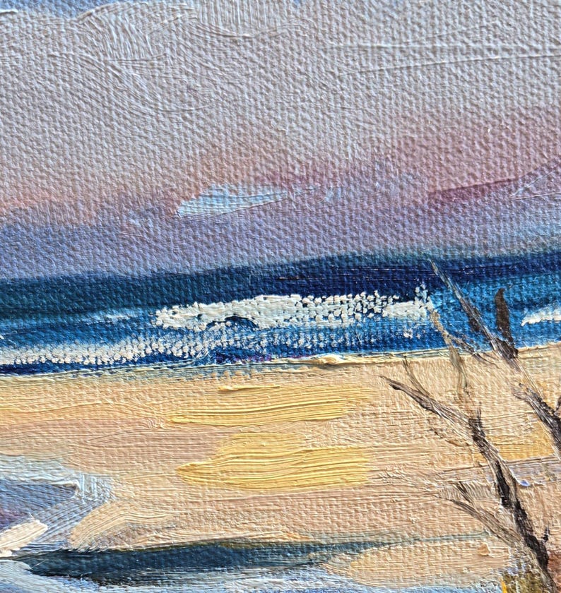May include: A painting of a seascape with a blue sky, blue water, and a sandy beach. The water is choppy and there are whitecaps on the waves. The beach is empty and there are some trees in the background.