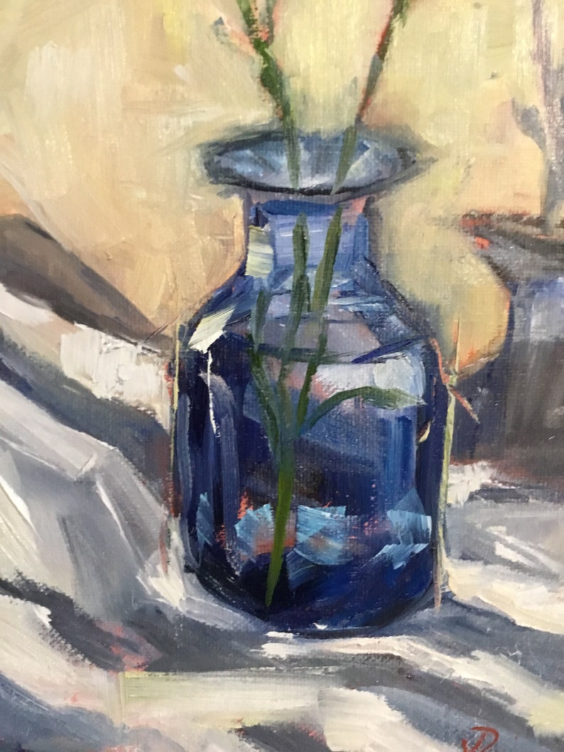 May include: A still life painting of a cobalt blue glass vase holding green stems. The vase is set against a backdrop of soft, neutral tones and a white cloth. The artwork is rendered with visible brushstrokes.