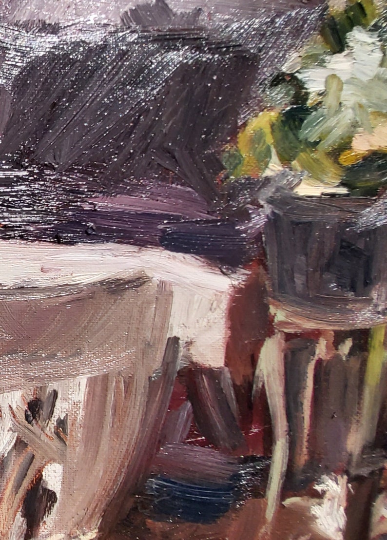 May include: A close-up of a still life painting featuring a potted plant with white flowers, a white table cloth, and a dark brown background.