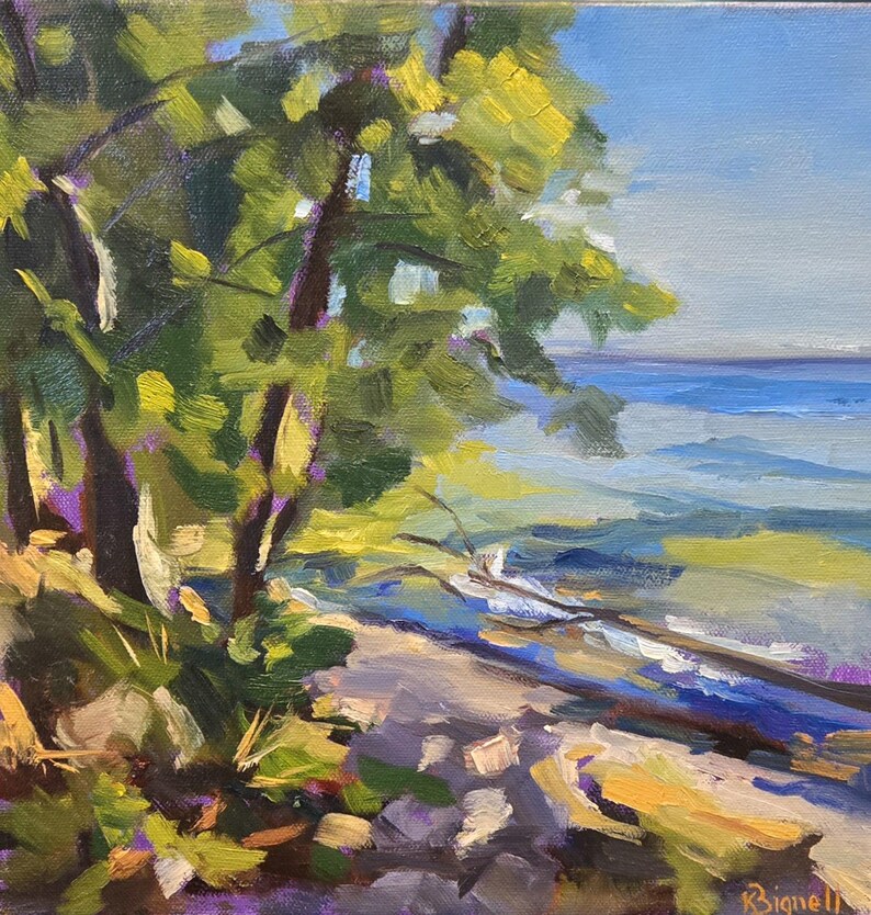 May include: A painting of a lakeshore scene with a bright blue sky and water. Lush green trees frame the view, with their branches reaching towards the water. The shoreline is a mix of sand and rocks, with a few small waves lapping at the shore.
