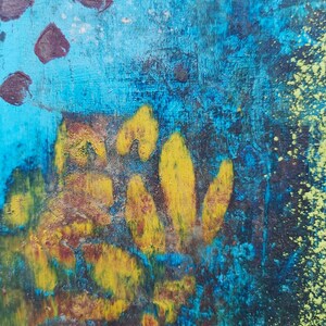 May include: Abstract painting with a blue background and yellow and brown shapes. The painting has a textured surface and a splattered effect.