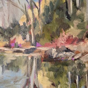 May include: A painting of a forest scene with a reflection of the trees in a still body of water. The trees are bare and the water is a light blue color. The painting is signed "Rignell" in the bottom right corner.