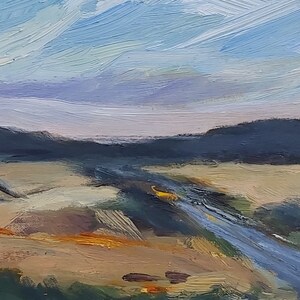 May include: A painting of a landscape with a blue river winding through a field of yellow grass. The sky is a light blue with white clouds. The painting is done in a loose, impressionistic style.