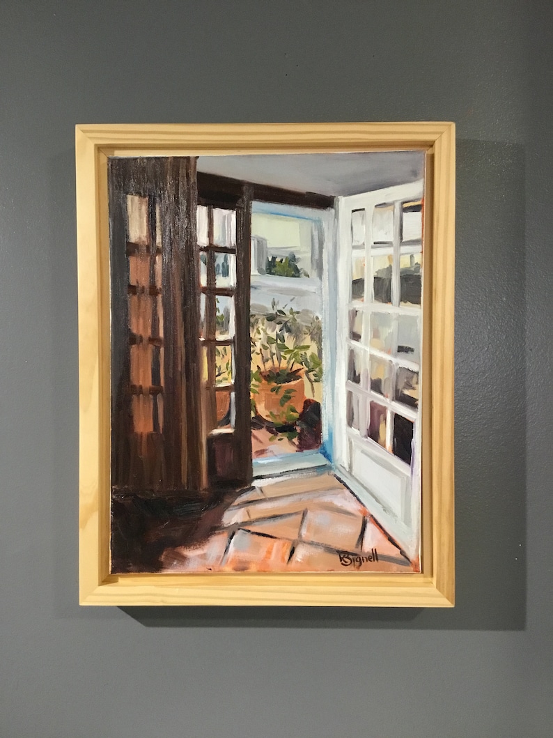 May include: A framed oil painting depicting a view from inside a home looking out through an open doorway. The doorway leads to a patio with a potted plant and a tiled floor. The painting is signed "Bignell" in the lower right corner.