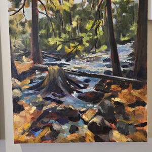 May include: Oil painting of a forest scene with a stream. The artwork features tall trees with brown trunks and green foliage. The stream has blue and white reflections, and the foreground has rocks and fallen leaves.
