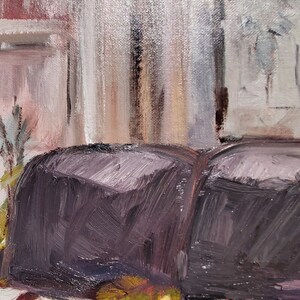 May include: A close-up of a dark purple loaf of bread sitting on a white surface with green and yellow vegetables in front of it.