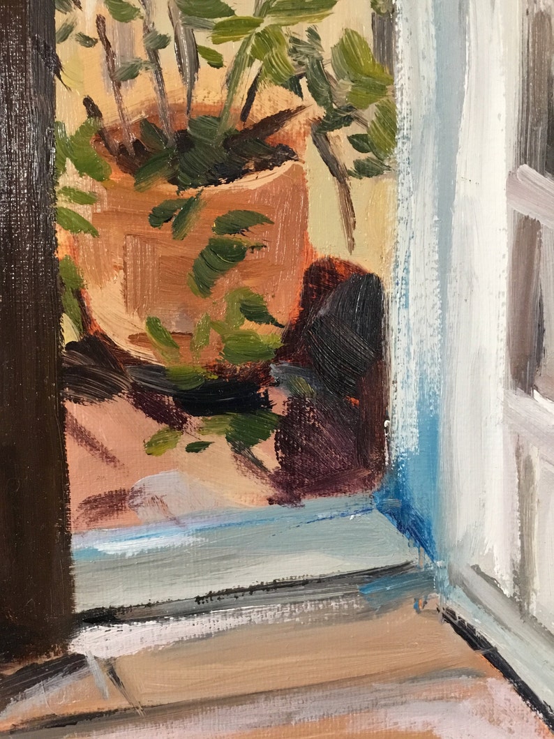 May include: A painting of a potted plant with green leaves in a terracotta pot, seen through a window with a blue and white frame. The plant is in focus, while the background is blurred.