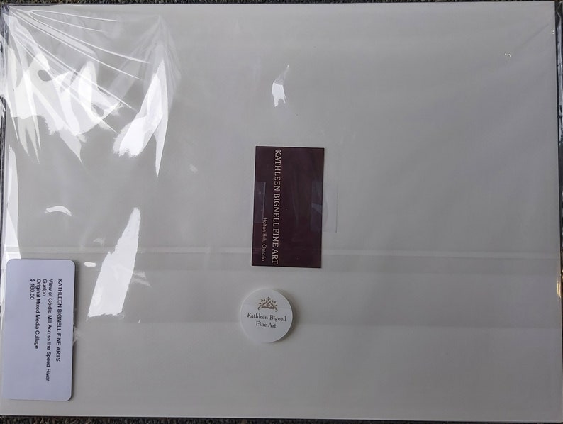 May include: A packaged artwork by Kathleen Bignell Fine Art. The artwork is a mixed media collage titled "View of Goldie Mill Across the Speed River" in Guelph. The package includes a sticker with the artist's name and a label with the artwork's title.