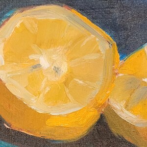 May include: A close-up of two lemon halves, one cut in half and the other cut into a wedge. The lemon halves are painted in a realistic style with yellow and white hues, and the background is a dark blue.